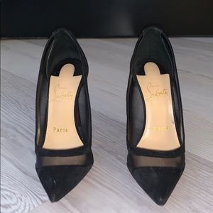 Black Christian Louboutin suede and mesh pumps.